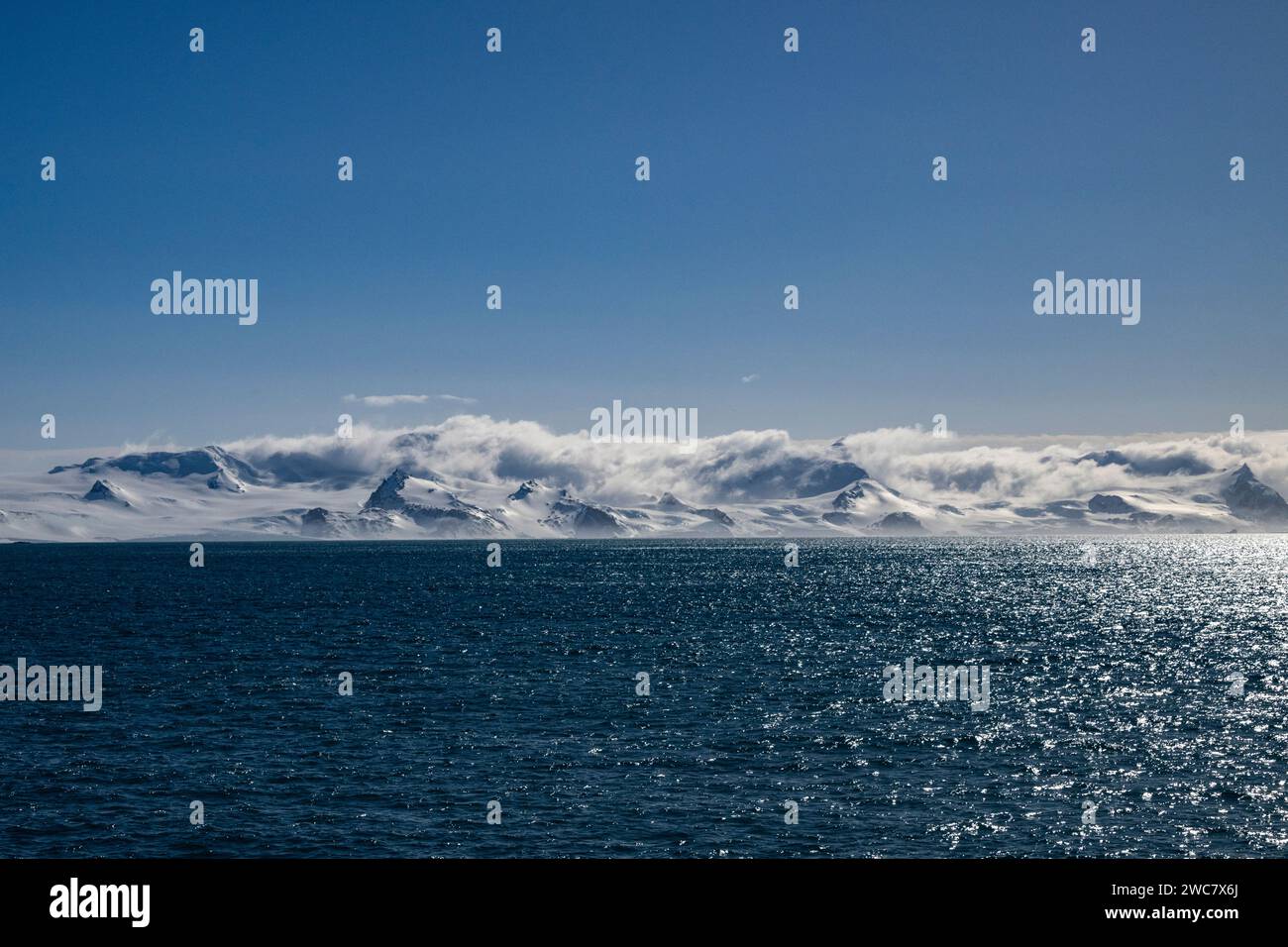 Elephant Island rocky shore and high snowcapped peaks, zodiac