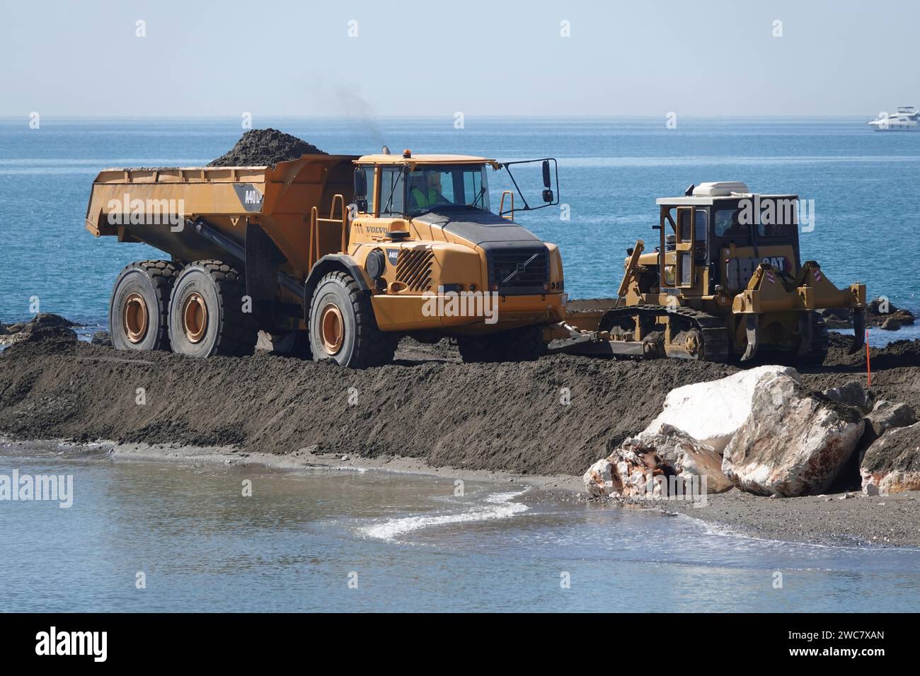 A Volvo A40D articulated hauler working on a coastal work site Stock Photo