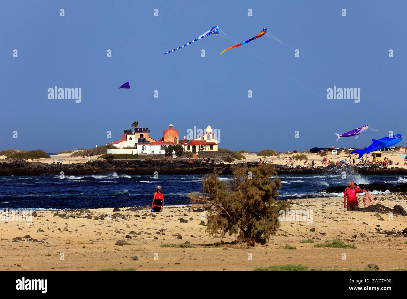 Colourful, large kites at La Concha beach, and the Dream House designed by architect and artist Antonio Padrón Barrera . Taken November 2023 Stock Photo