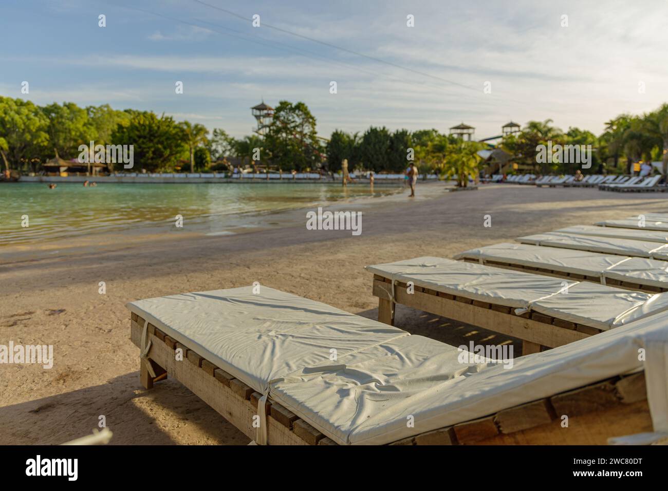 Empty lounge chairs in front of a pool. Stock Photo