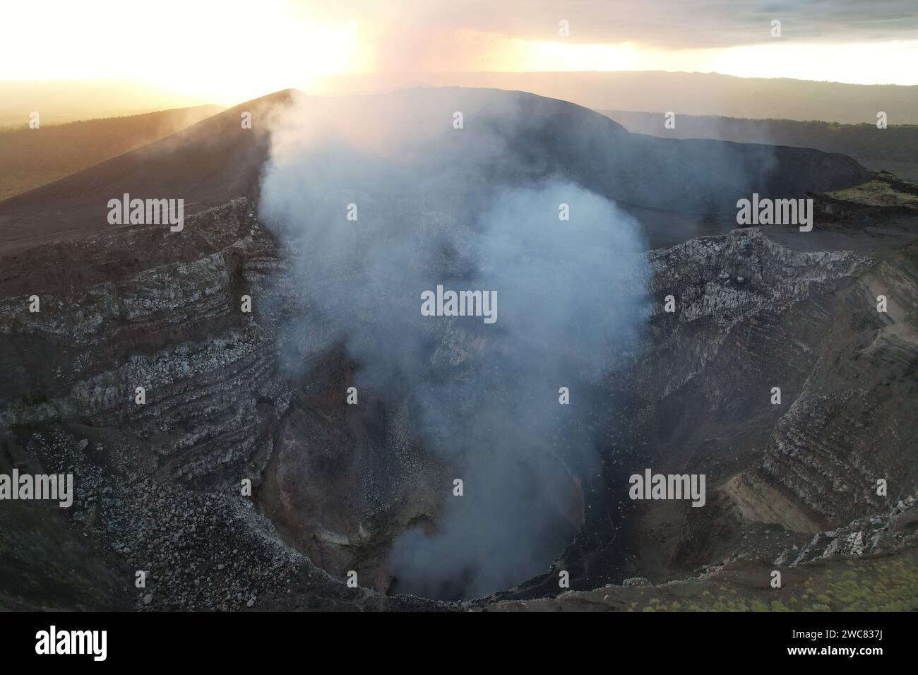 Masaya volcano crater on sunset time with smoke going up Stock Photo