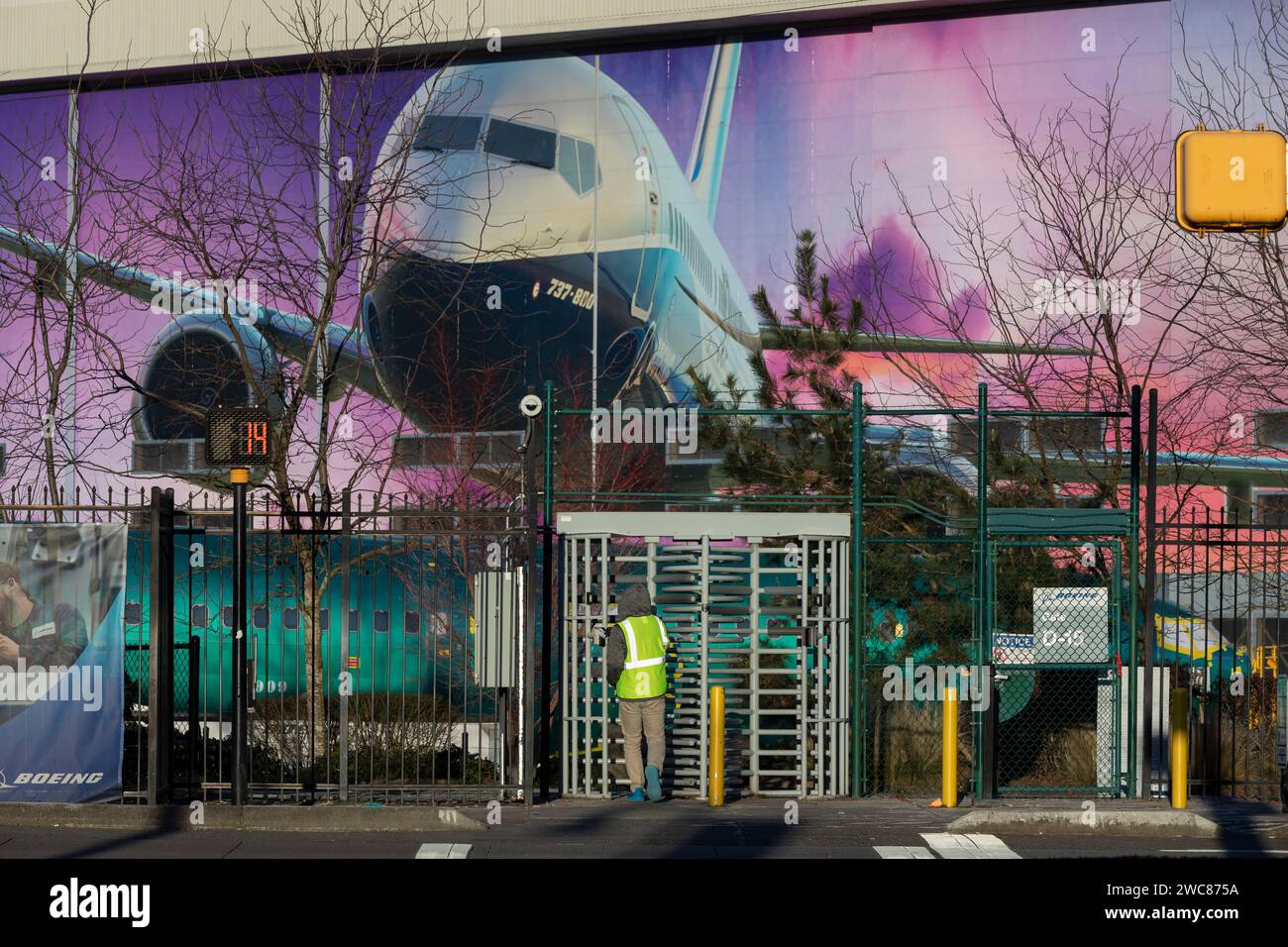 Renton, Washington, USA. 14th January, 2024. An employee enters a gate at the Boeing Renton Factory. The U.S. Federal Aviation Administration has announced increased oversight of Boeing production and manufacturing following an incident on a Boeing Model 737-9 MAX in which the aircraft lost a passenger door plug while in flight. Credit: Paul Christian Gordon/Alamy Live News Stock Photo
