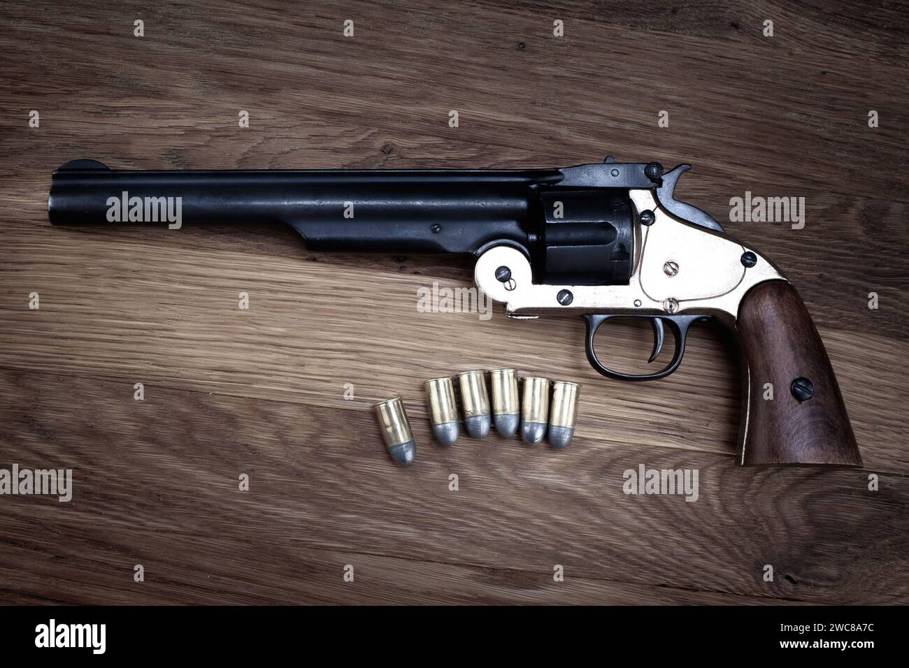 Old West .44 caliber single action revolver with rounds on wooden ...