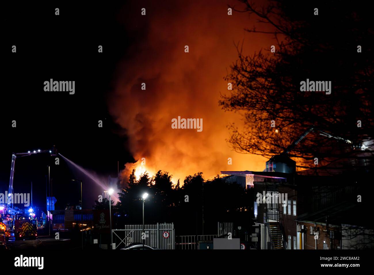 Newport, UK. 14th January 2024.   Firefighters battle to put the fire out at the Wern Industrial Estate in Rogerstone in Wales on 14th January 2024.   This image may only be used for Editorial purposes. Editorial use only.  Credit: Ashley Crowden/Alamy Live News Stock Photo