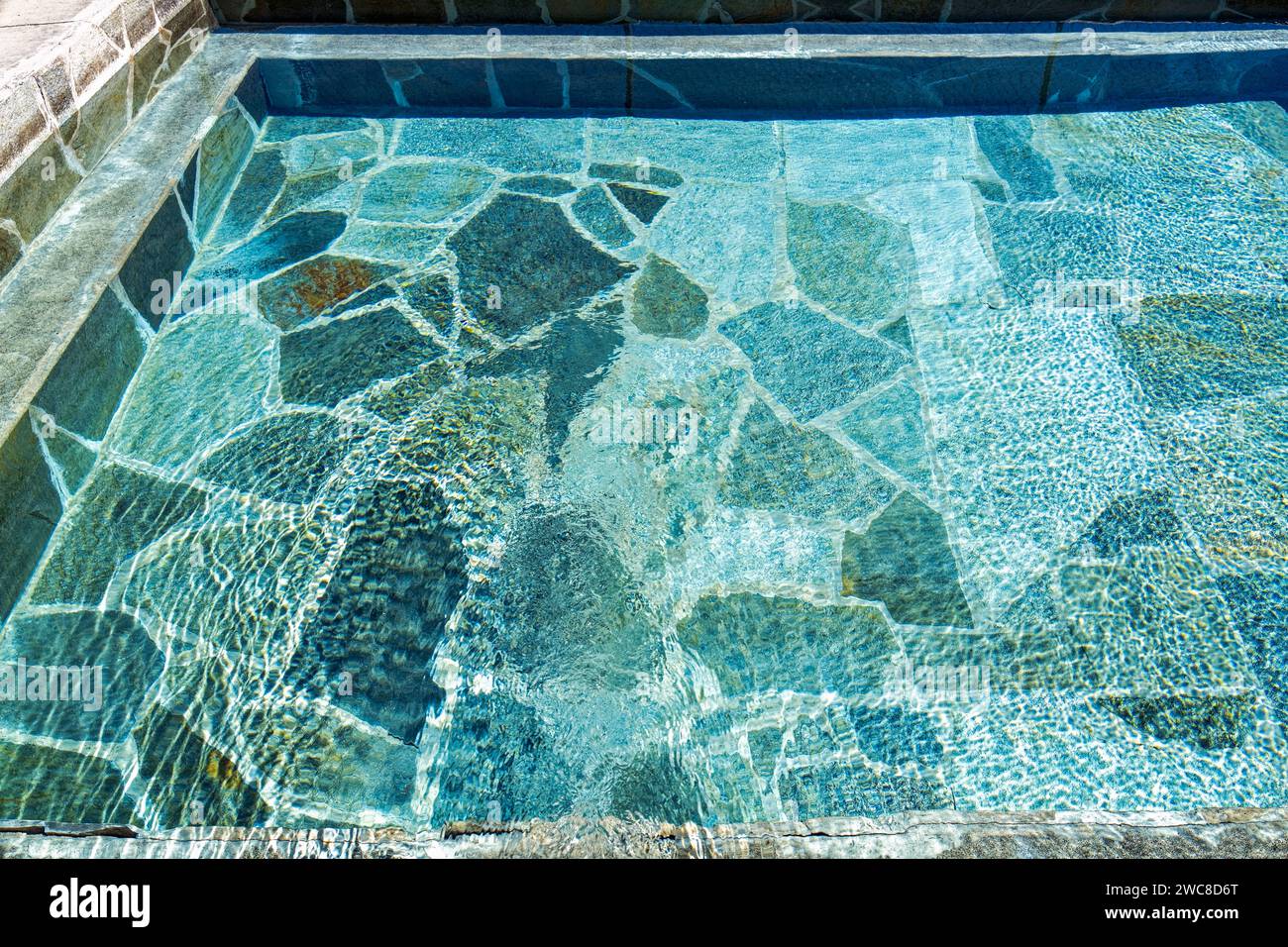 The abstract patterns in a pool with natural stone tiles Stock Photo