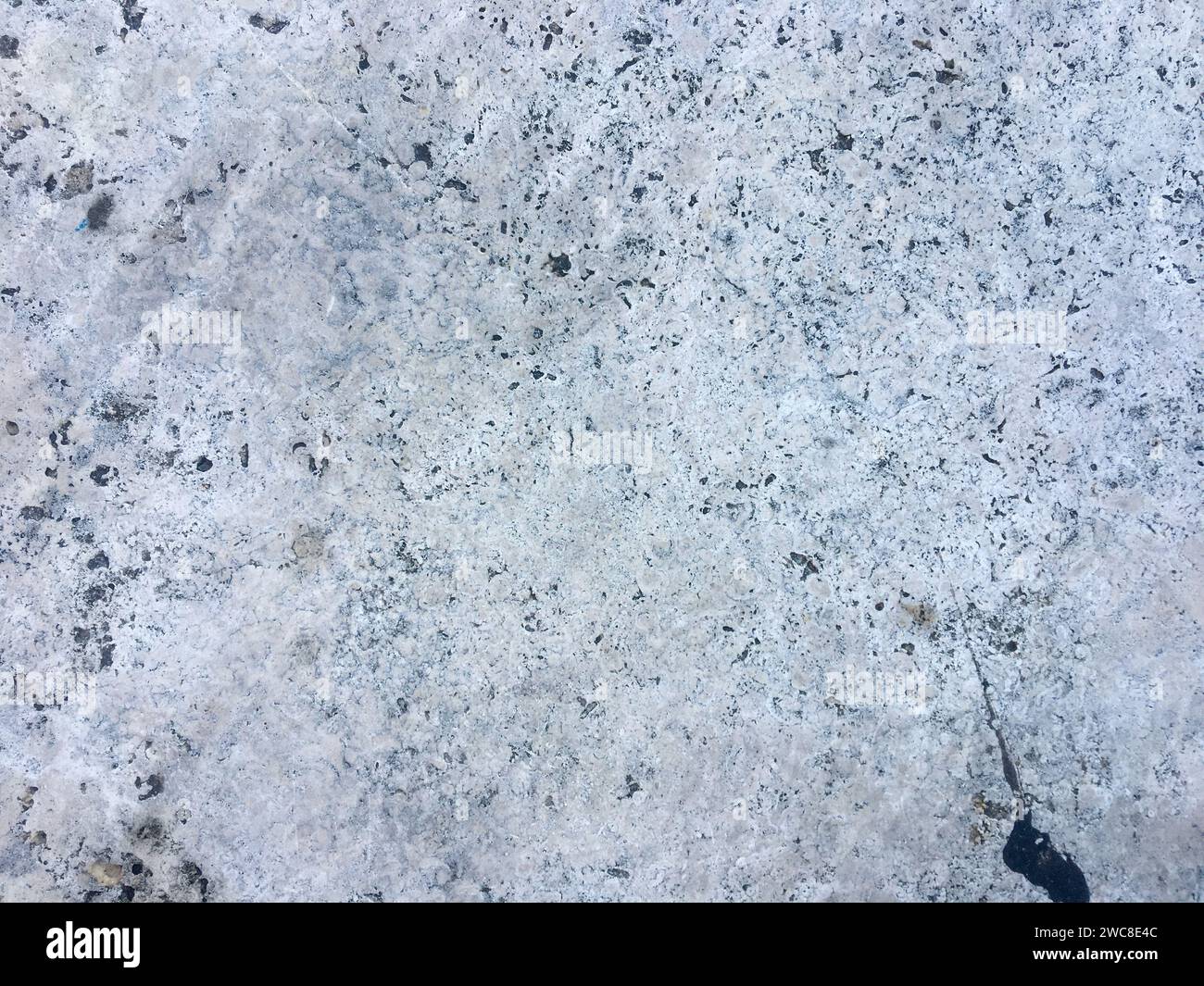 A bright and rough concrete backdrop on a white background. Stock Photo