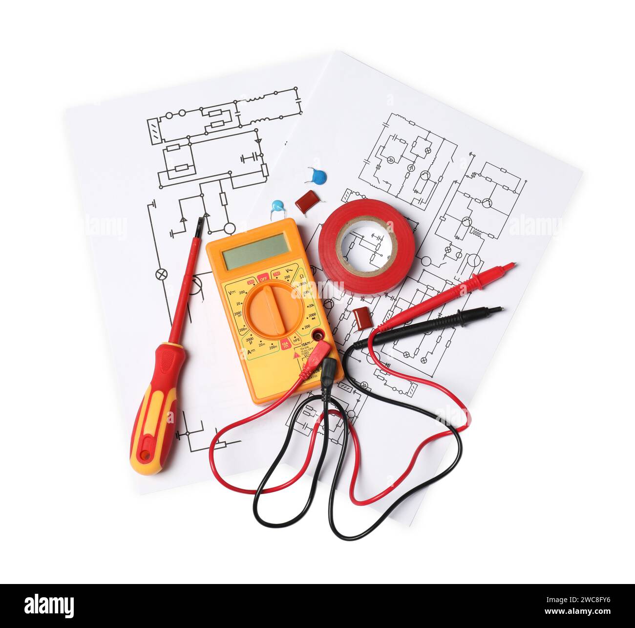 Wiring diagrams, digital multimeter and screwdriver isolated on white