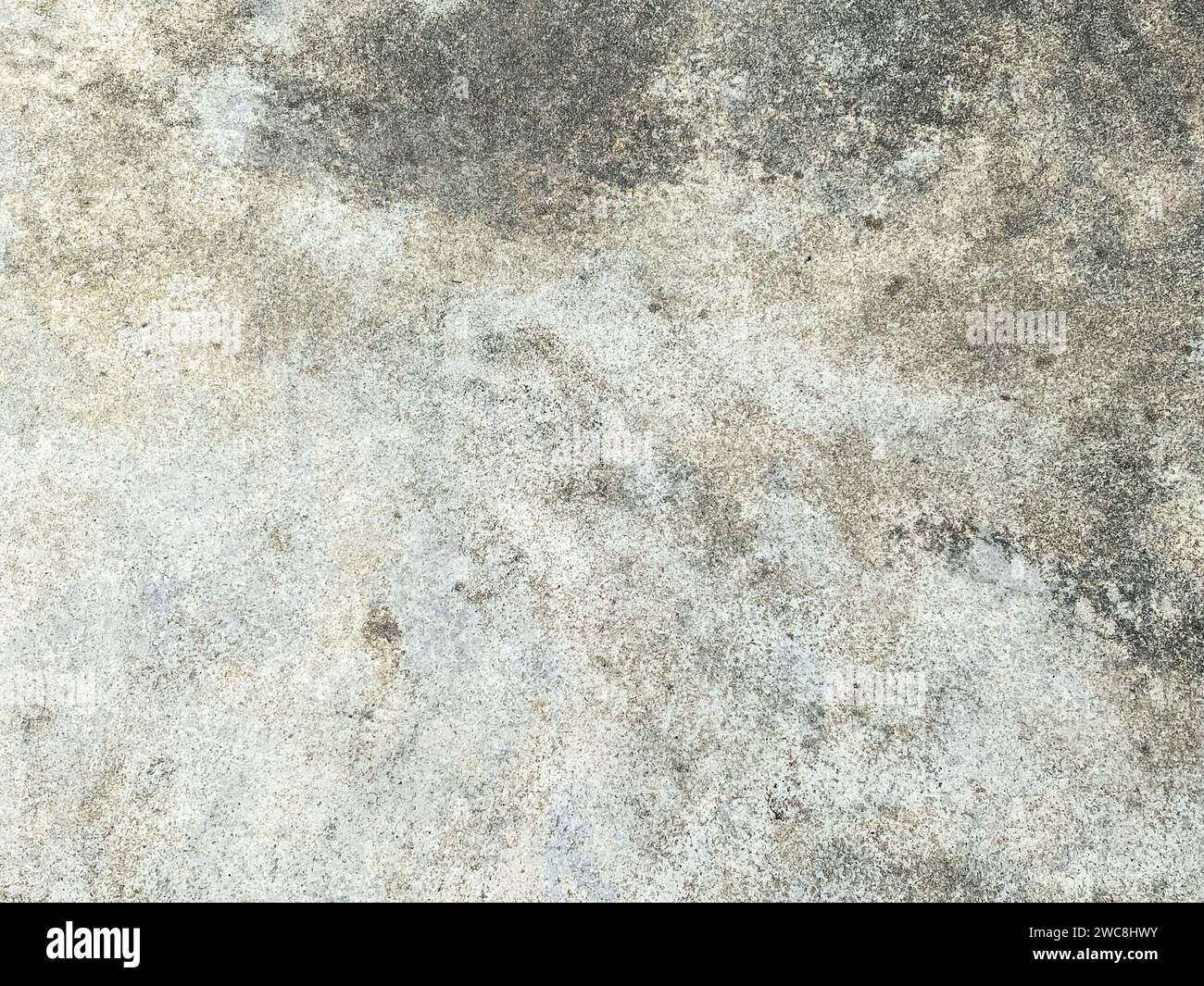 The intricate patterns on the cement wall create a mesmerizing abstract design. Stock Photo