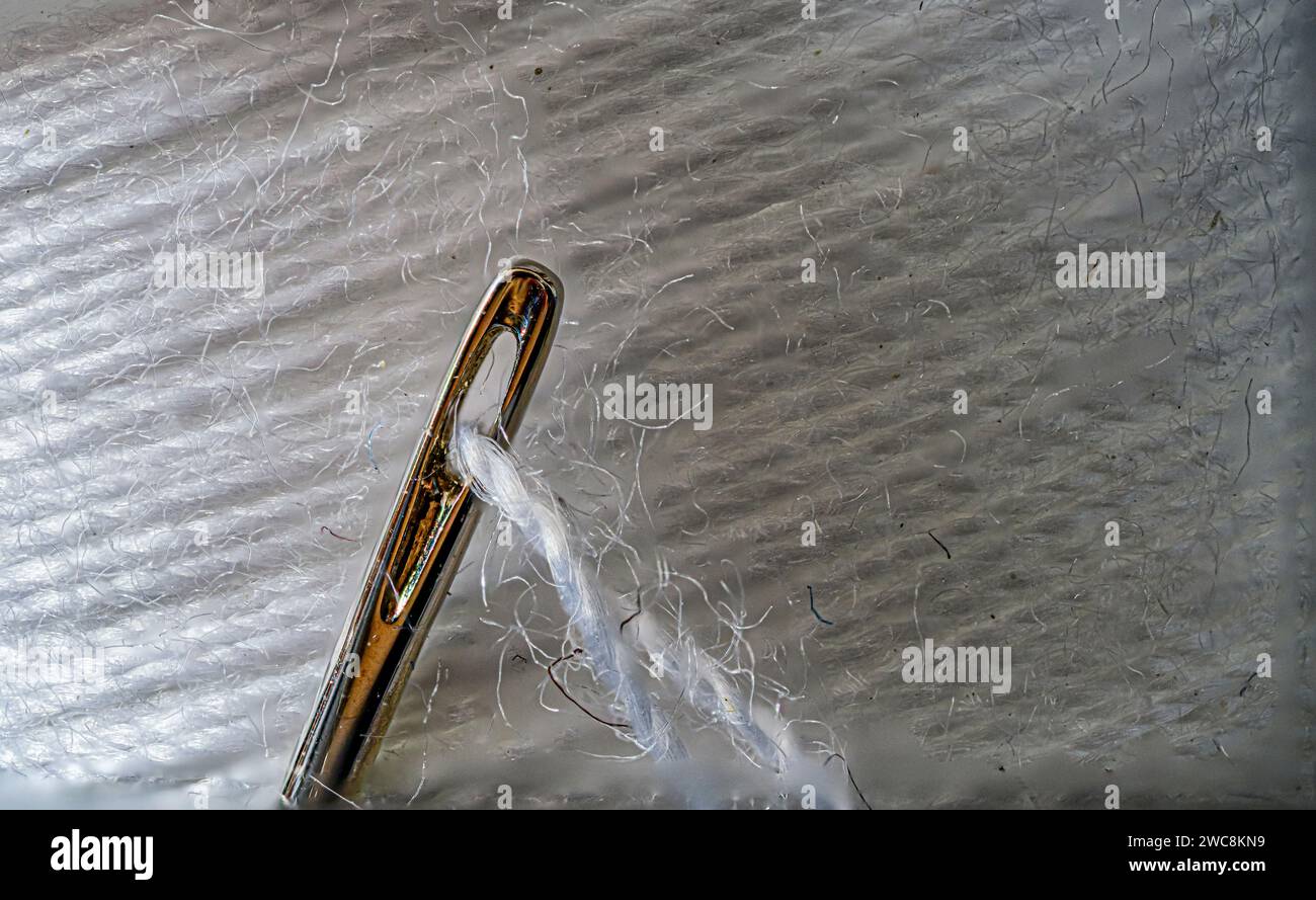 Sewing needle with spool of thread Stock Photo