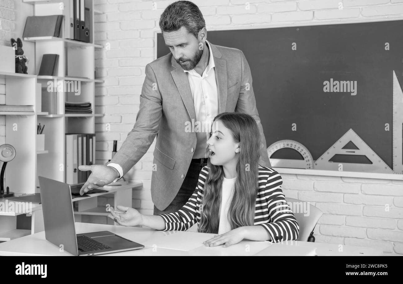 amazed child with teacher in classroom use laptop Stock Photo - Alamy