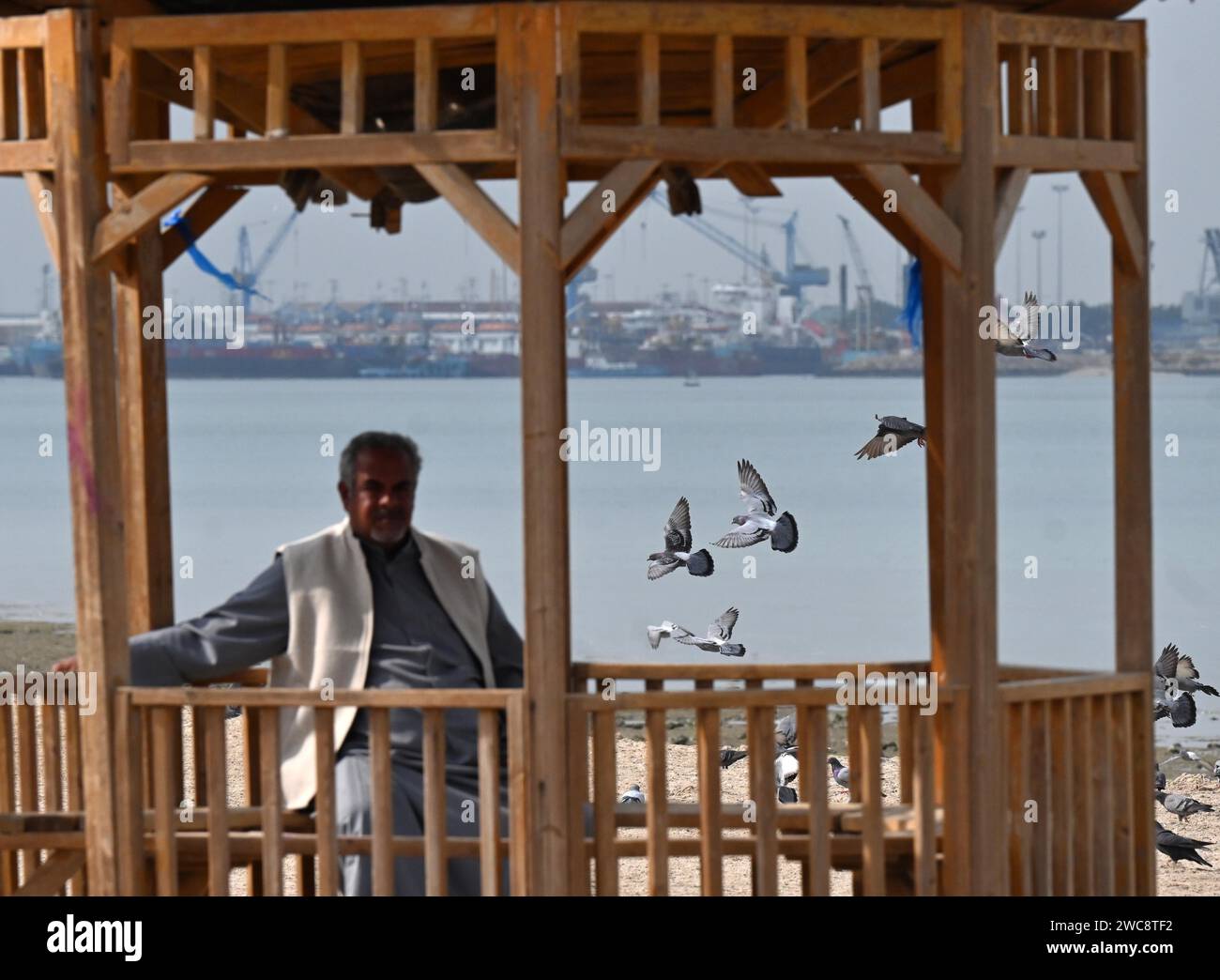 Kuwait City, Kuwait. 14th Jan, 2024. A man rests by the seaside in