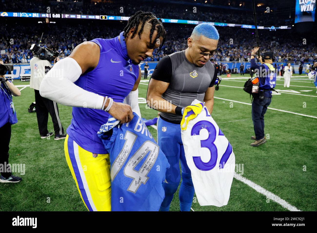 Detroit Lions wide receiver Amon Ra St. Brown right and Los Angeles Rams safety Quentin Lake swap jerseys after the second half of an NFL wild card playoff football game Sunday Jan. 14 2024