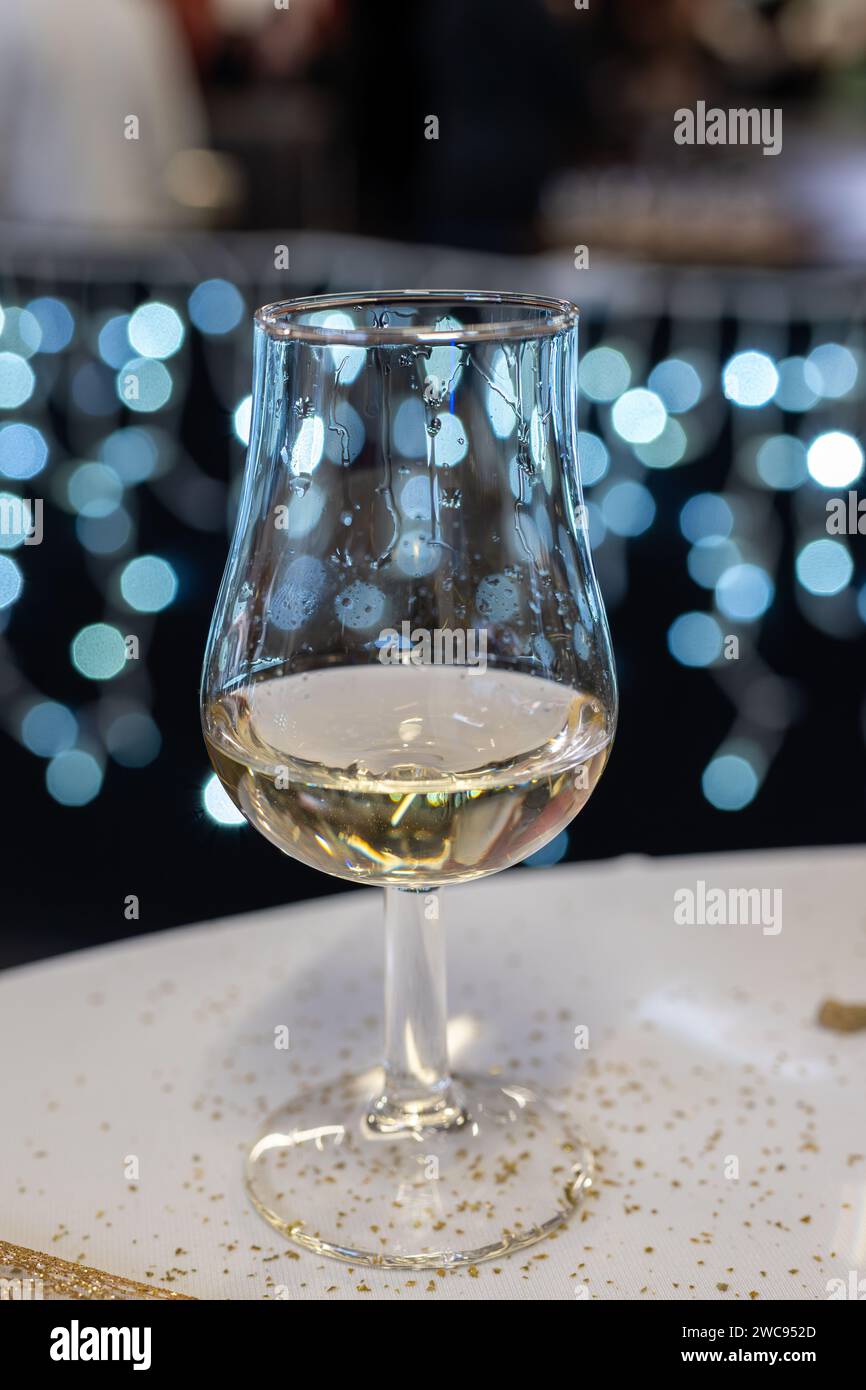 Small tasting glass of sparkling wine champagne on winter festival in December, Avenue de Champagne, Epernay, Champagne region, France Stock Photo