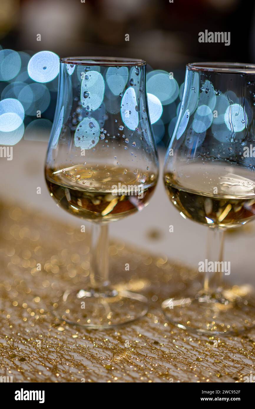 Small tasting glasses of sparkling wine champagne on winter festival in December, Avenue de Champagne, Epernay, Champagne region, France Stock Photo