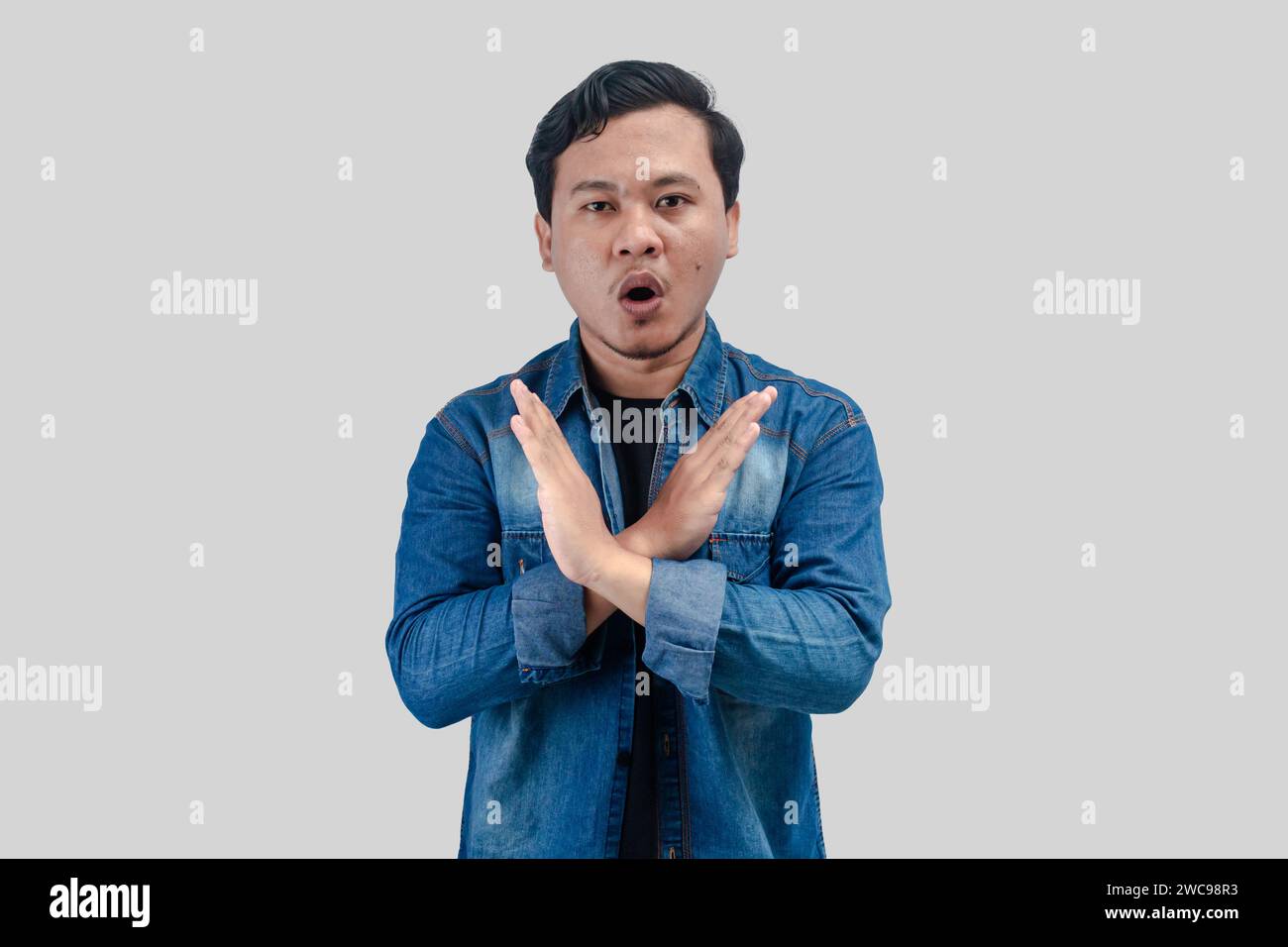 Young Asian Man unhappy or confident standing wear holding two