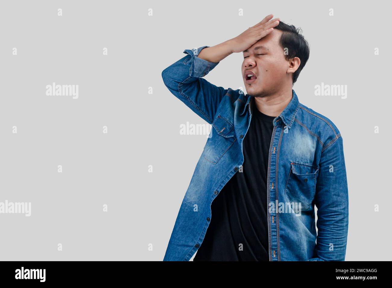 Young Asian Man with head palm gestures in disbelief expressions. On Isolated background Stock Photo