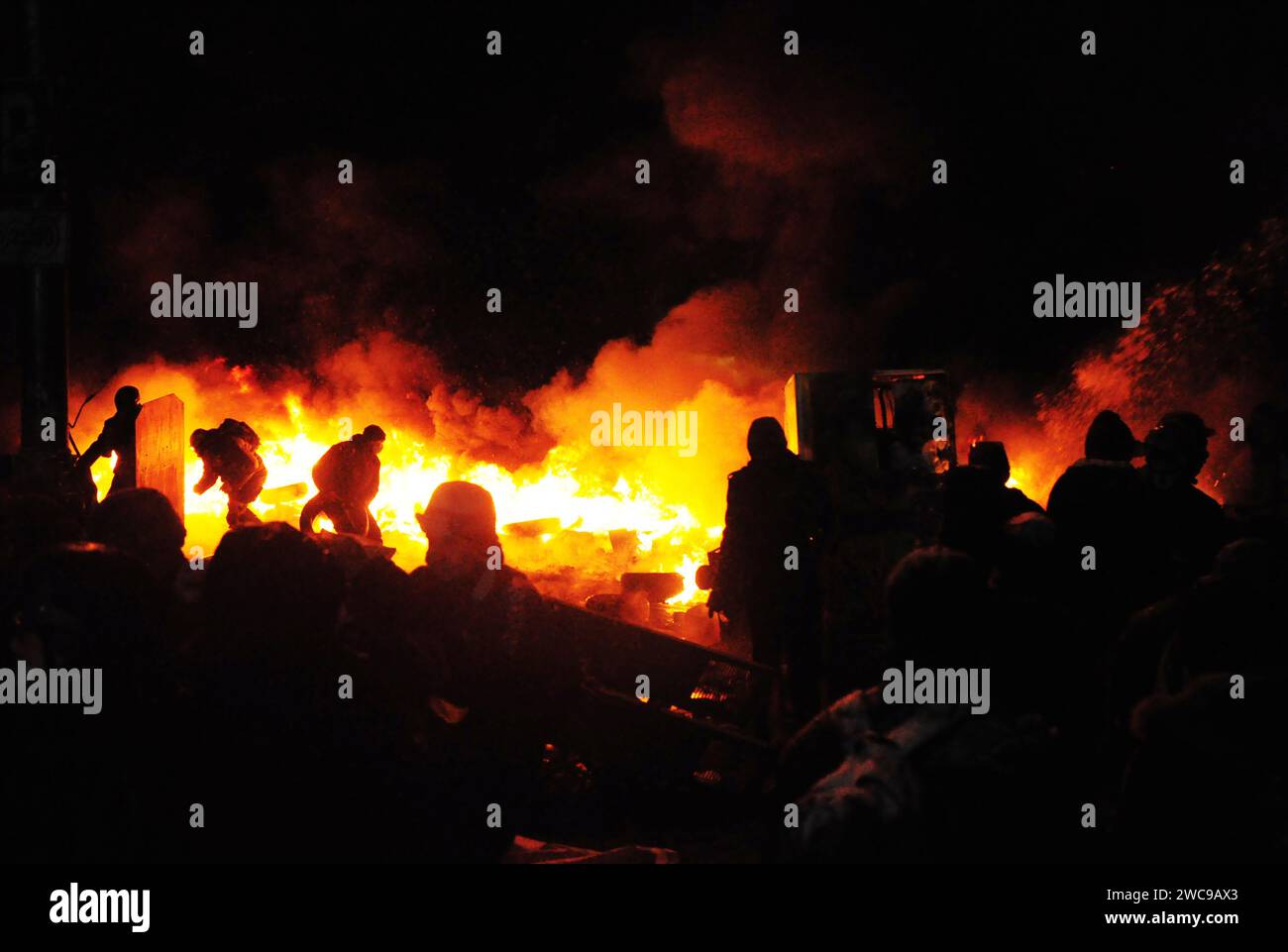 Riot: protesters set cars on fire and clash with a police. Stock Photo