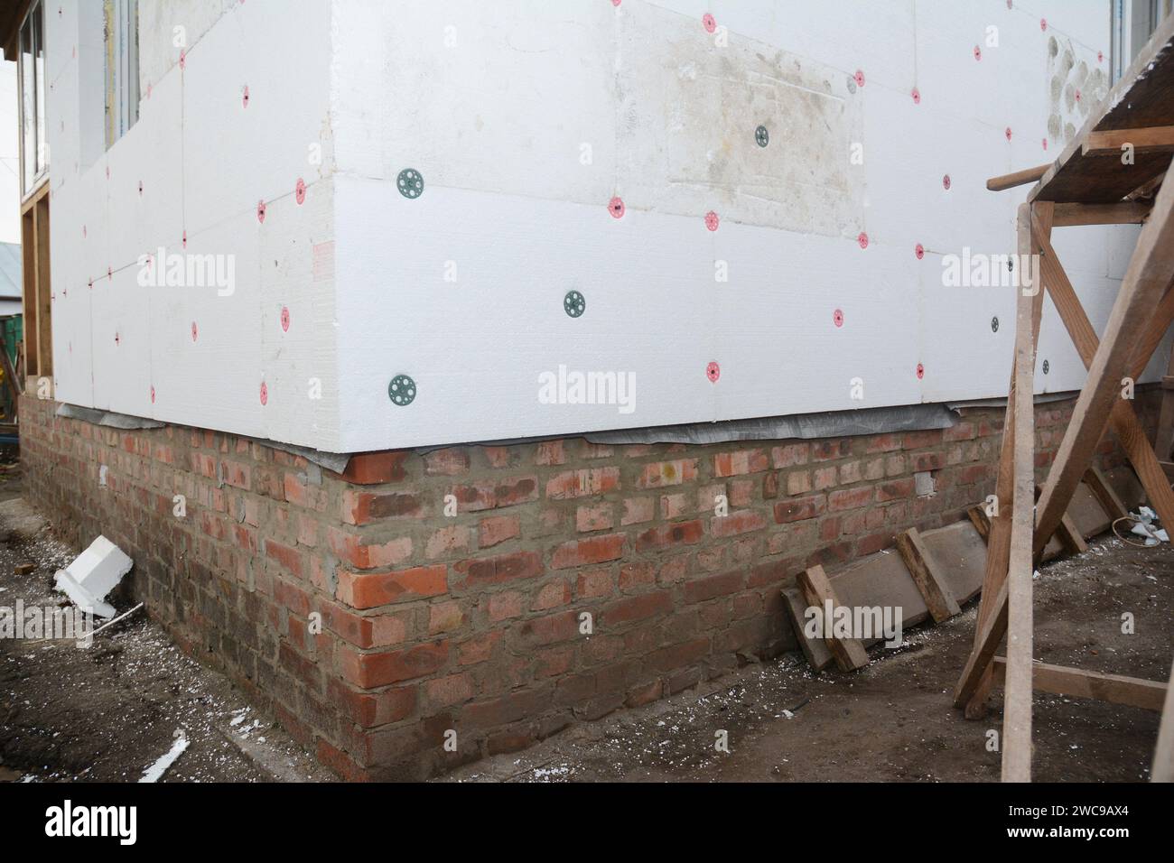 External wall rigid foam board insulation. A close up of a house corner