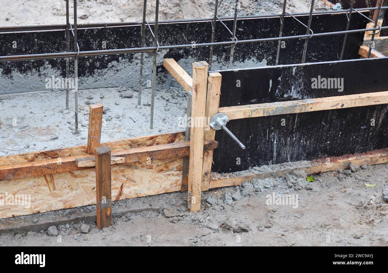Building a concrete masonry foundation wall, installing the footings