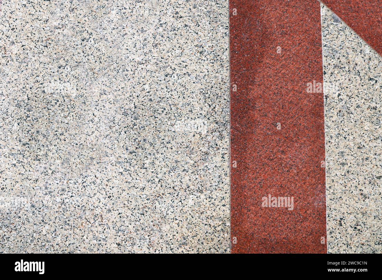 Horizontal or vertical background with natural granite tiles floor. Granite texture backdrop with vintage rhomboidal tile of red and gray color. Polis Stock Photo