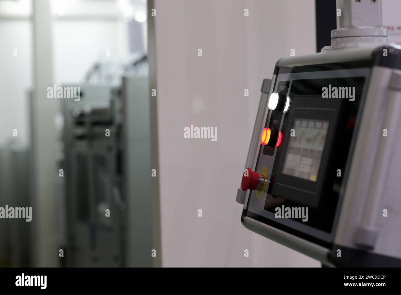 Modern industrial pendant touchscreen control console. Selective focus. Stock Photo