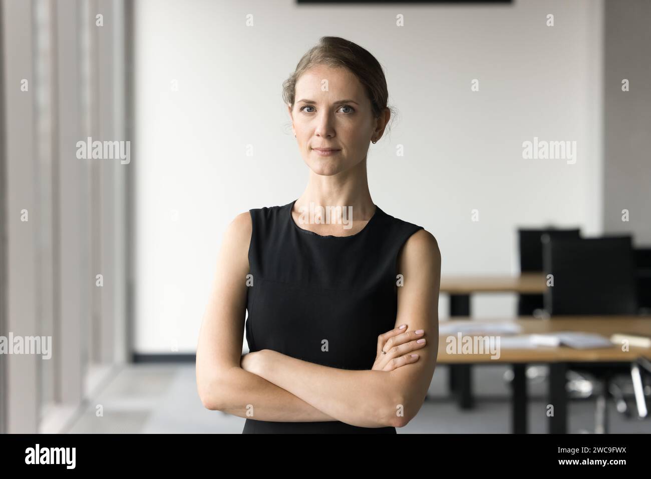 Serious attractive young businesswoman posing in office space Stock Photo