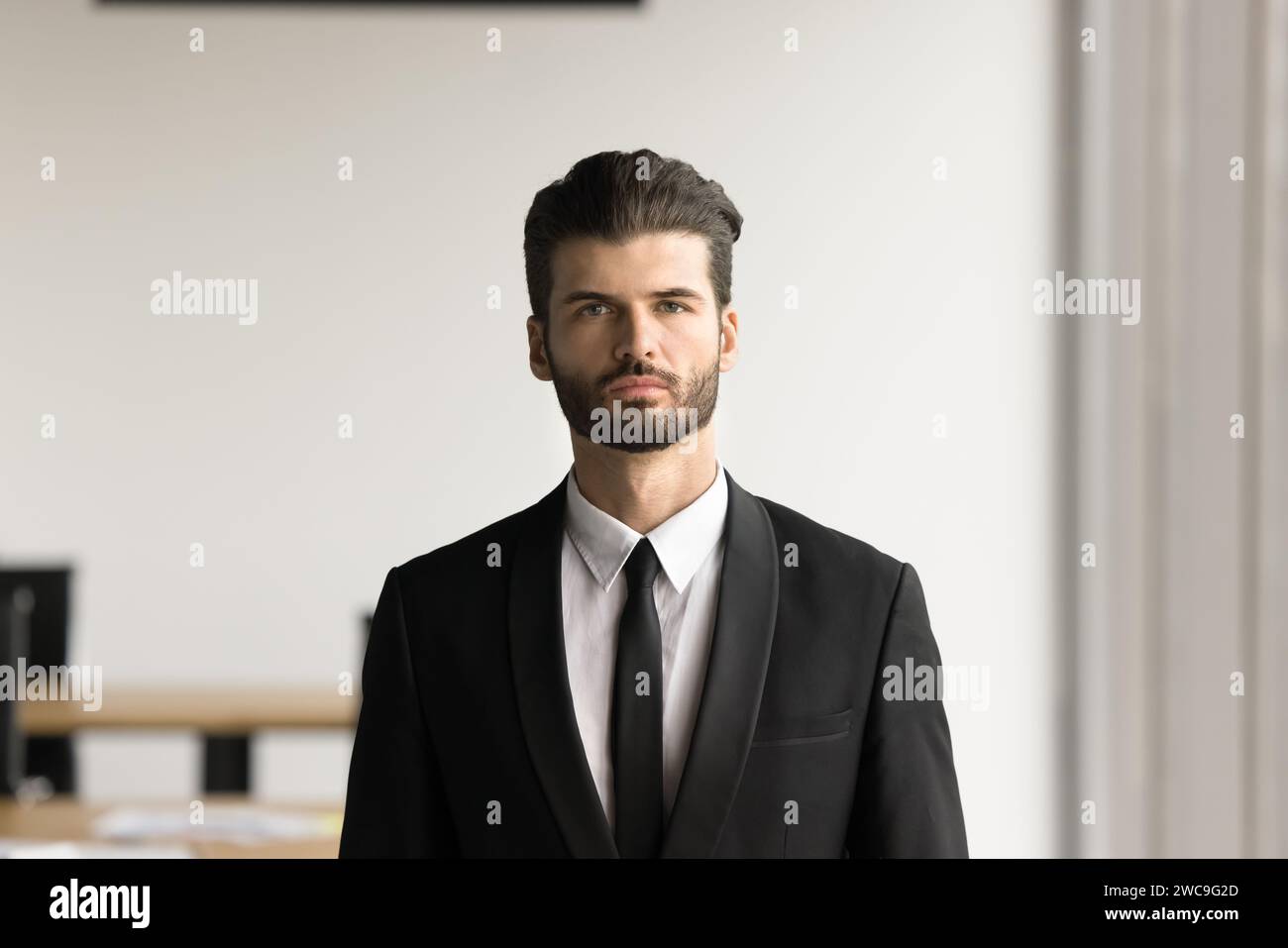 Serious handsome young executive man looking at camera Stock Photo
