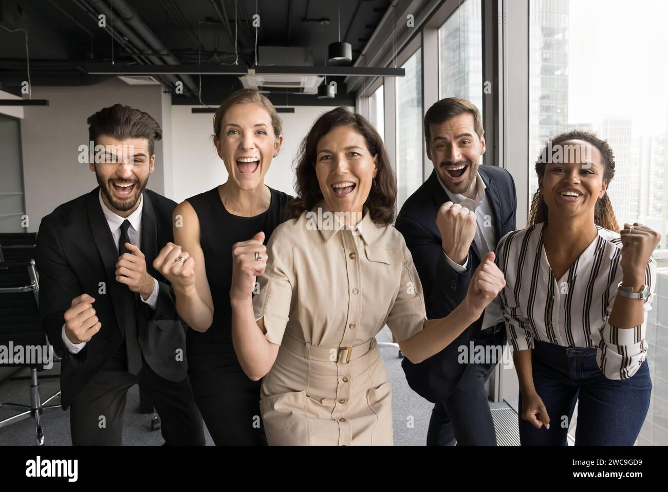 Excited group of business colleagues celebrating team success Stock Photo