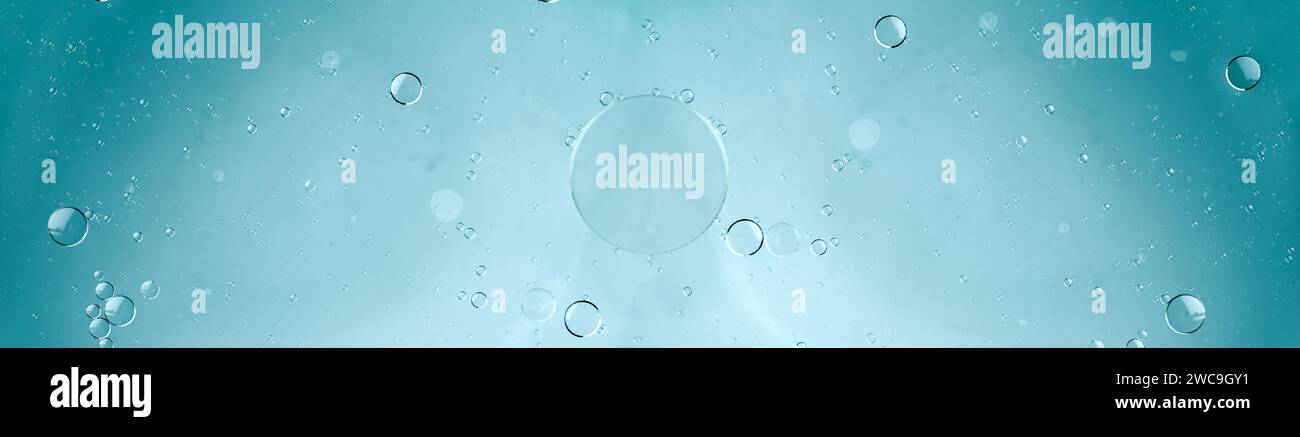 Oil and water, transparent blue bubbles, soap suds with water blue background. Space for copy Stock Photo
