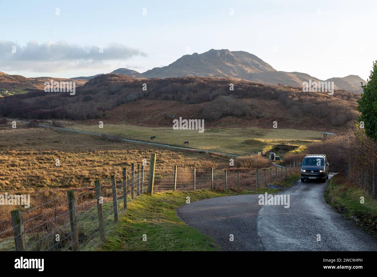 A campervan on a rural single track road on the Ardnamurchan Peninsula with the hill Beinn na Seilg in the background Stock Photo