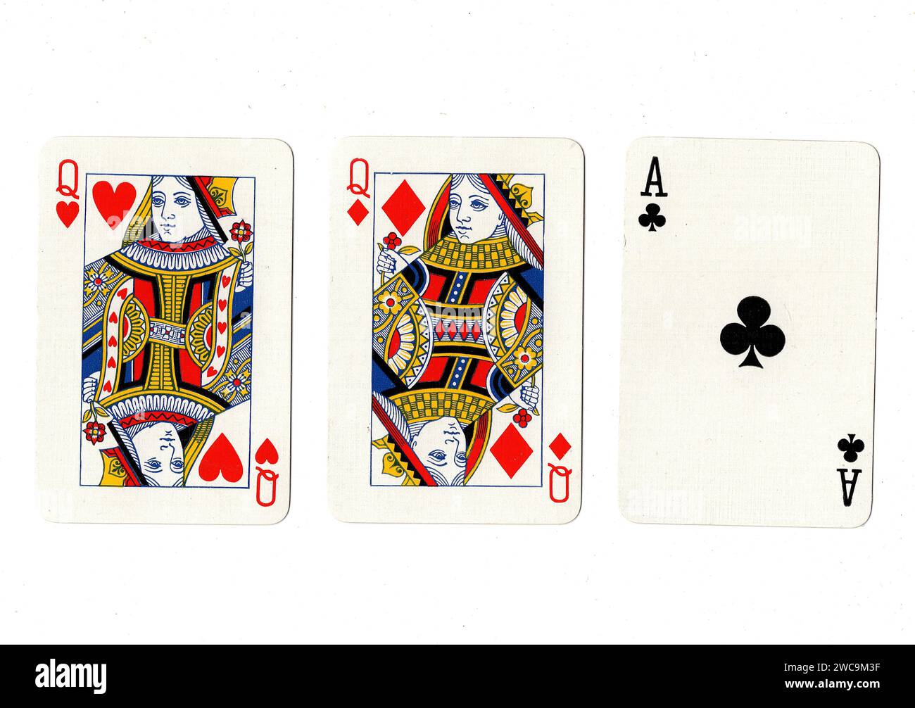 Vintage playing cards showing a pair of red queens and a black ace isolated on a white