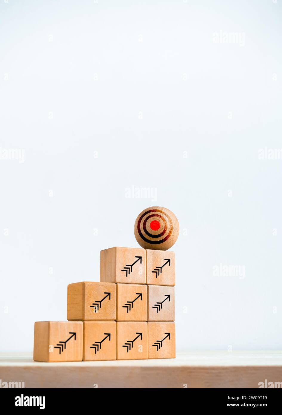 Big target icon on wooden sphere on top of cube blocks bar graph chart ...
