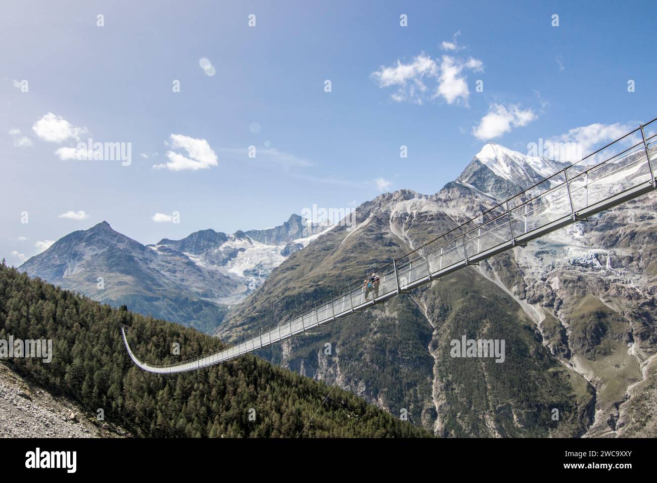 Hikers on Charles Kuonen Suspension Bridge, Valais, Switzerland Stock Photo