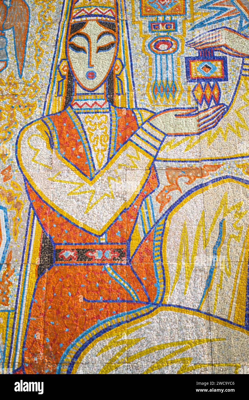 Detail in a large, colorful socialist, modernist Soviet, Russian tile mosaic of a woman with earings. At the mountain top tourist amusement park area Stock Photo