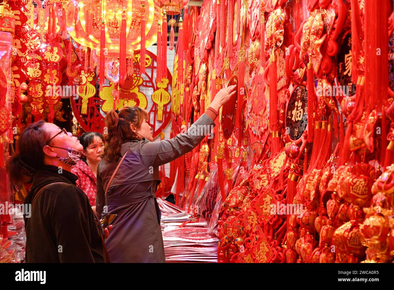 People are buying lanterns and other mascot ornaments with dragon elements at a traditional Chinese New Year shopping street in Nanning, China, on January 14, 2024. (Photo by Costfoto/NurPhoto) Stock Photo