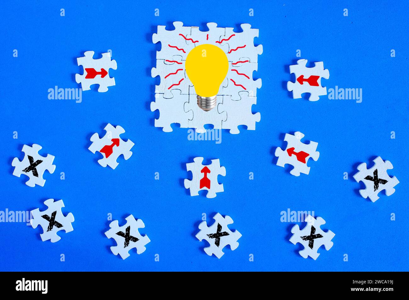 Business concept,collaboration,cooperation,teamwork, innovation,human resources,recruitment,team building with jigsaw puzzle pieces arrows, light bulb Stock Photo