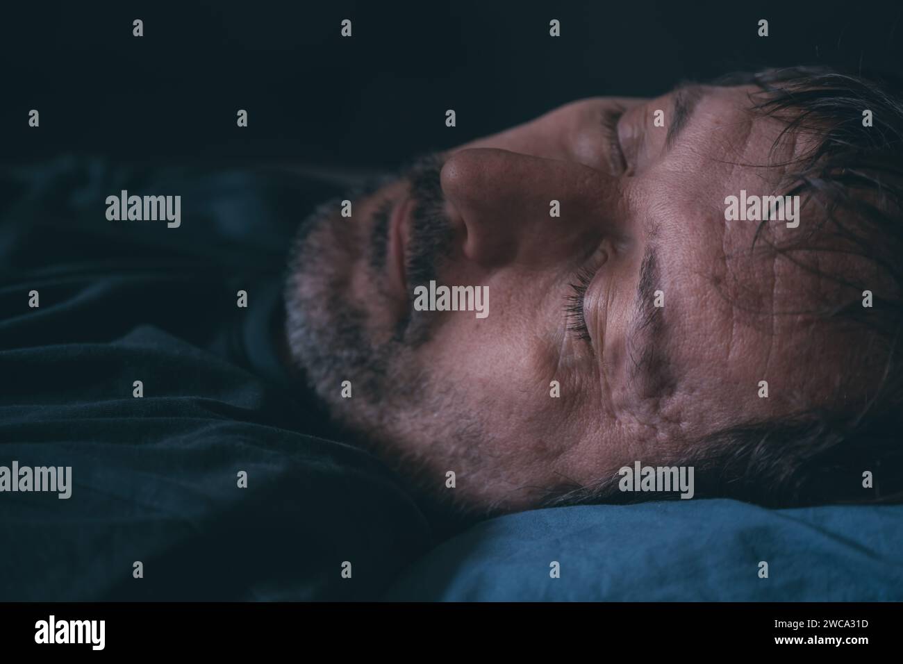 Man sleeping in bed, close up of face, selective focus Stock Photo
