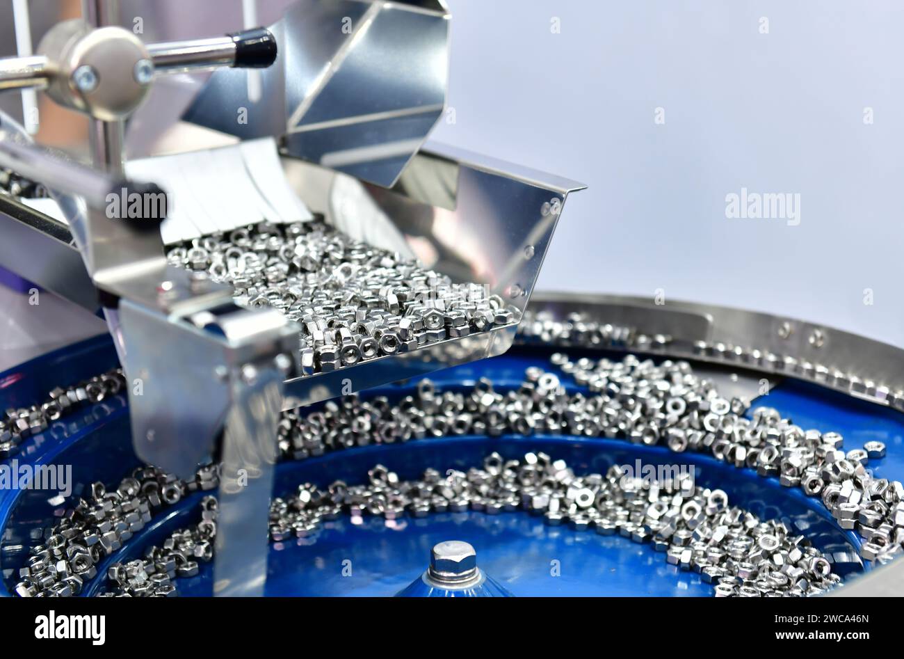 Many small bolts and nuts by manufacturing process in factory Stock