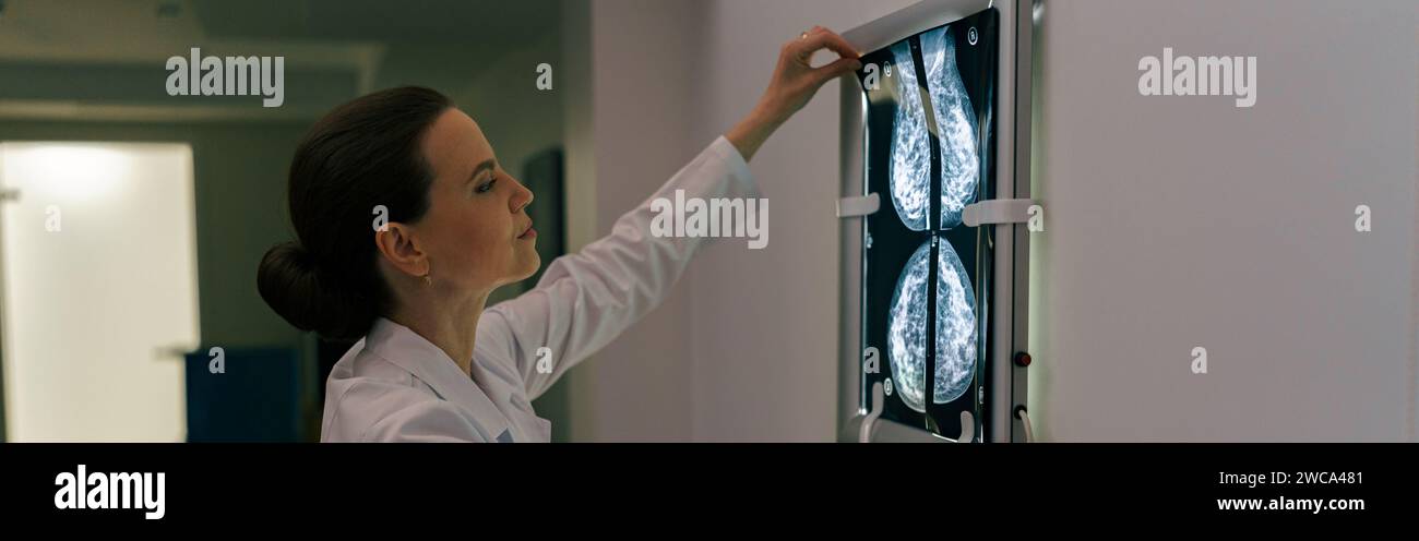 Focused professional doctor radiologist analyzing scan MRI images in ...
