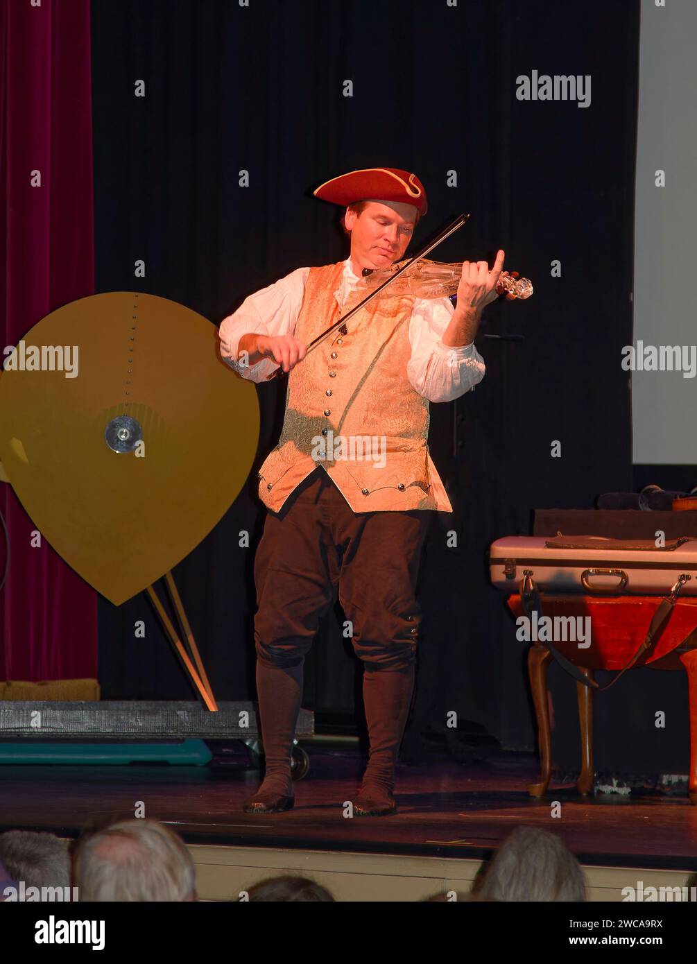 musician, playing glass violin, colonial garb, tricorn hat, stage, show