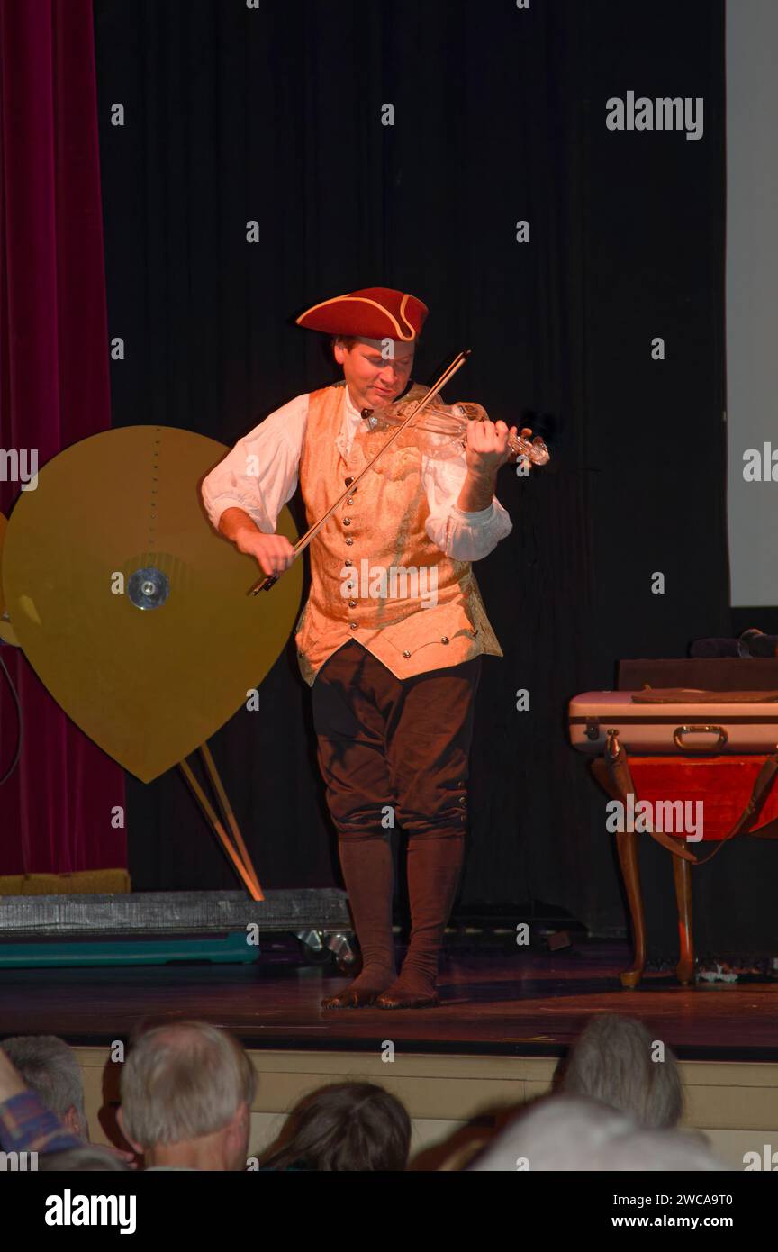 musician, playing glass violin, colonial garb, tricorn hat, stage, show