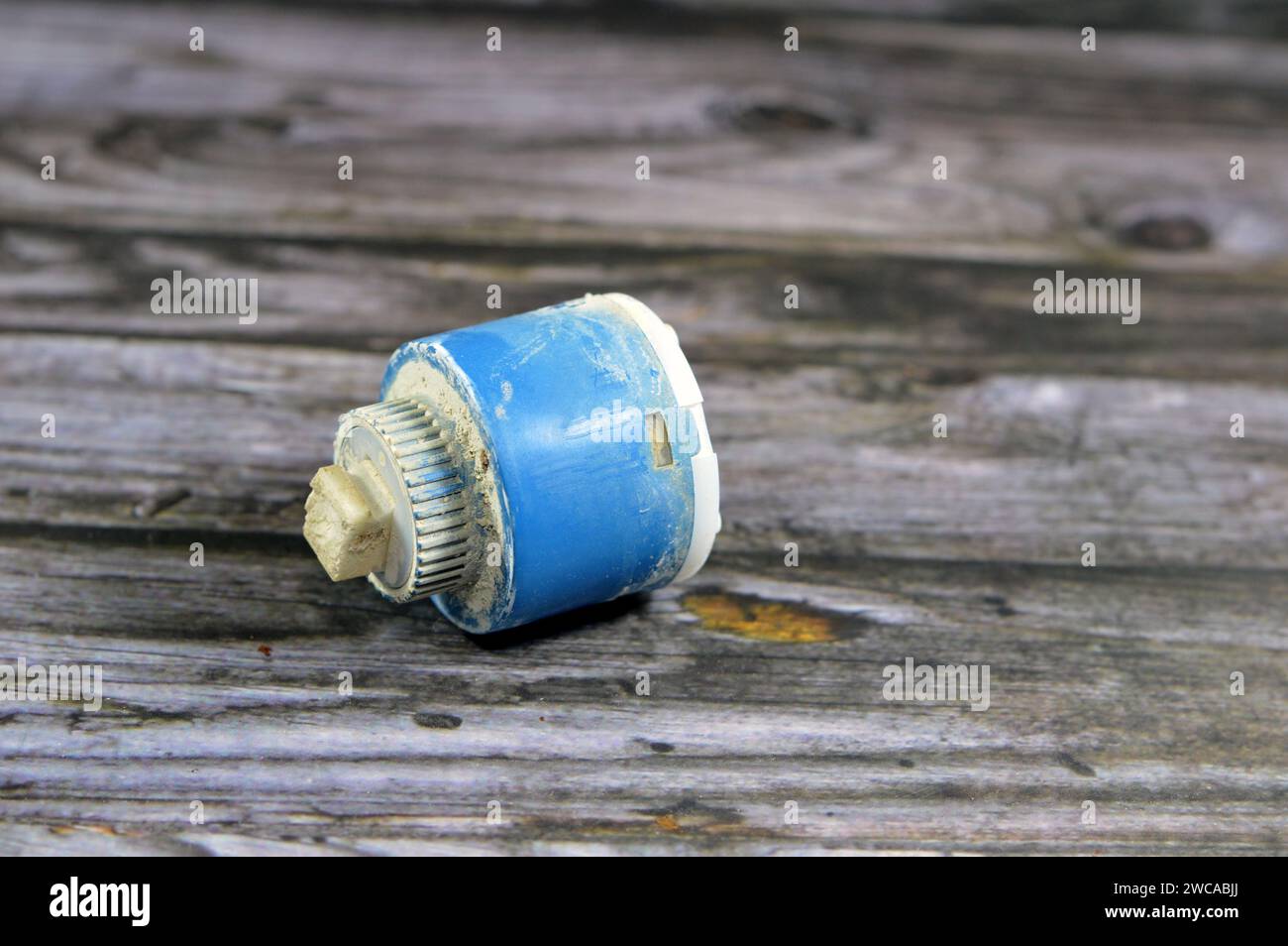 A used broken shower faucet tap body cartridge parts of plastic that