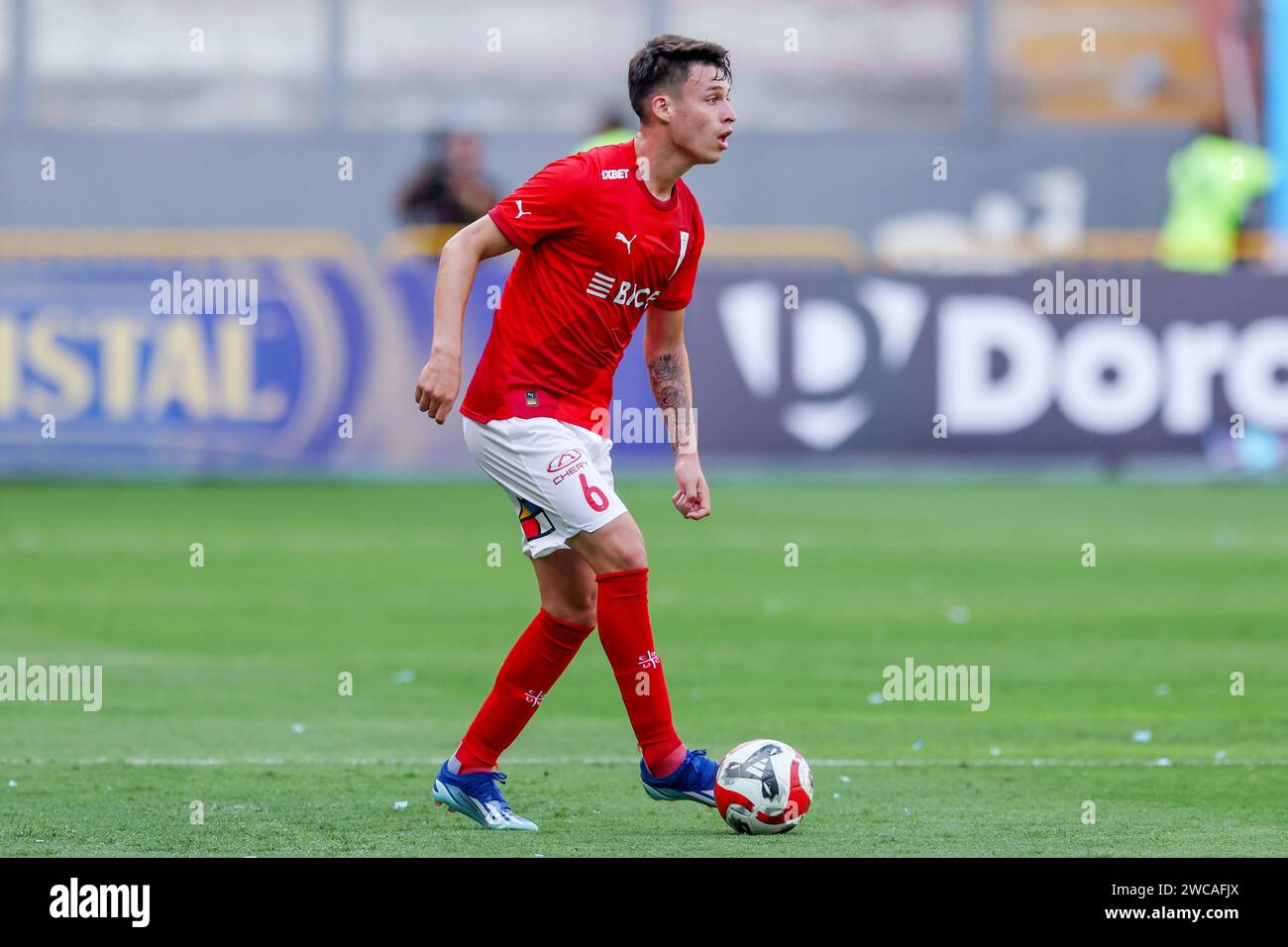 Lima, Peru. 14th Jan, 2024. Alfred Canales of Universidad Catolica during the friendly match between Sporting Cristal and Universidad Catolica de Chile played at Nacional Stadium on January 14, 2024 in Lima, Peru. (Photo by Miguel Marrufo/PRESSINPHOTO) Credit: PRESSINPHOTO SPORTS AGENCY/Alamy Live News Stock Photo