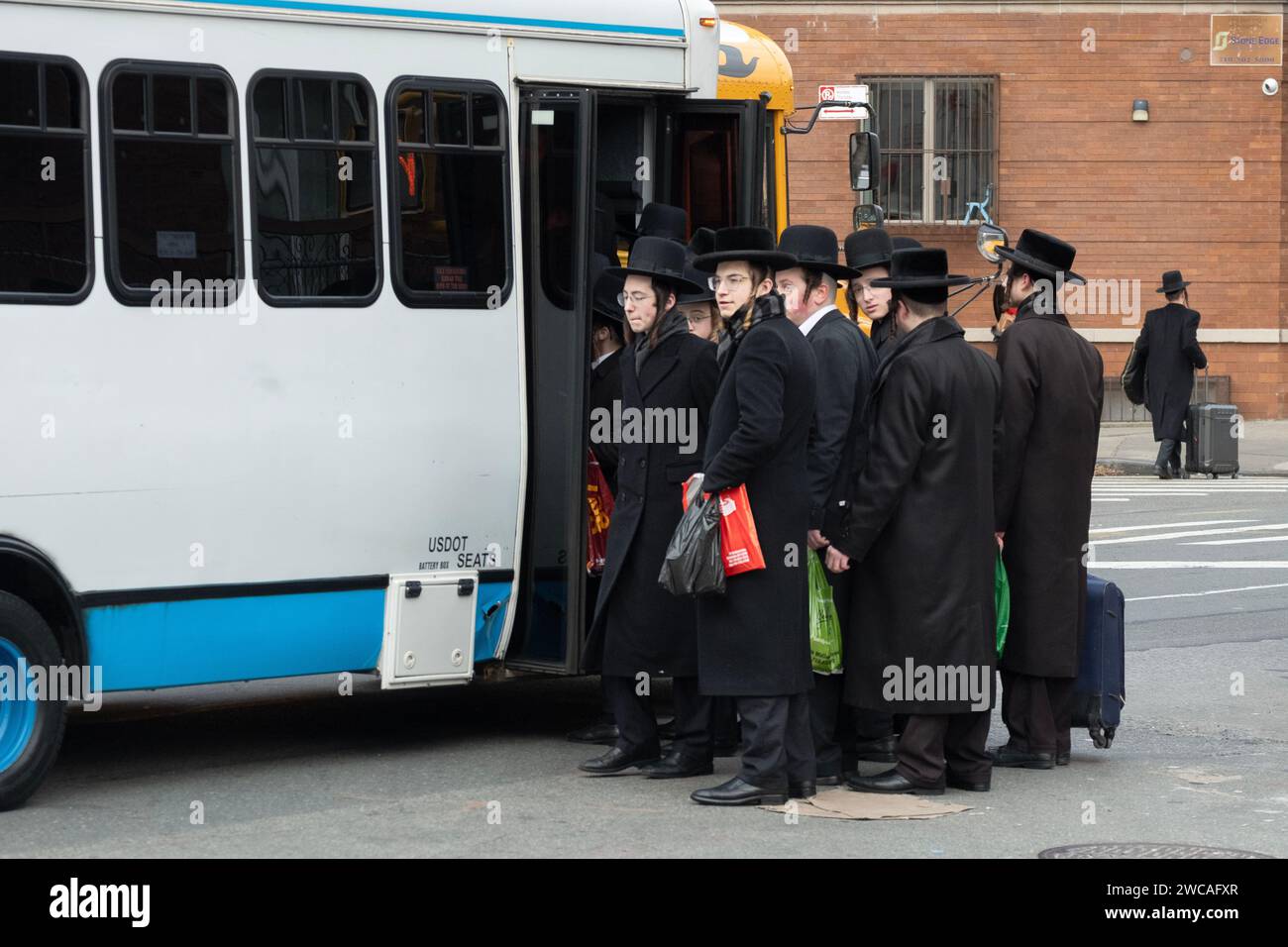 On a cold winter day, orthodox Jewish young men board a bus to attend a Talmud study group on the other side of Brooklyn. Bedford Ave in Williamsburg. Stock Photo