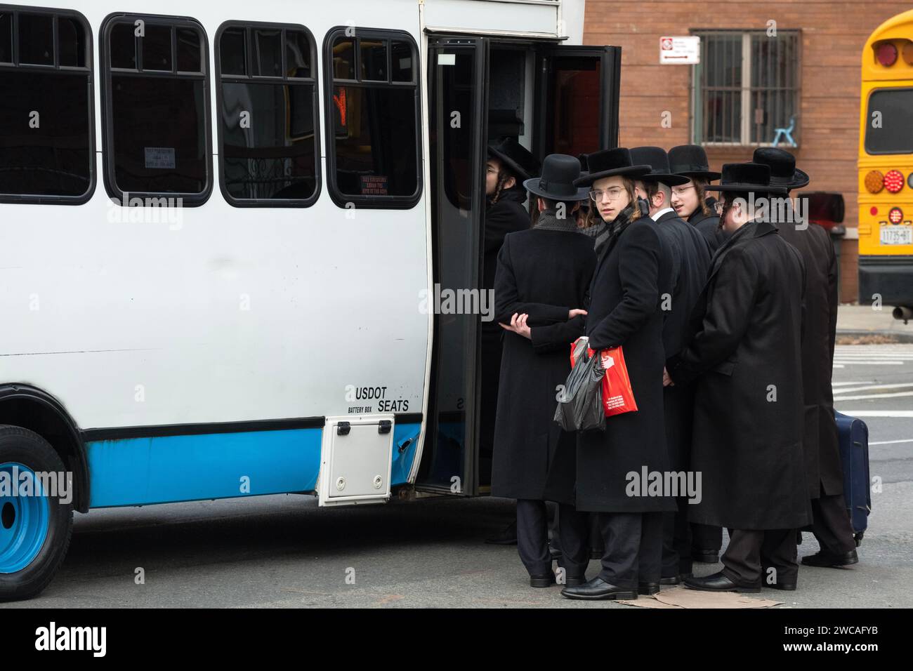 On a cold winter day, orthodox Jewish young men board a bus to attend a Talmud study group on the other side of Brooklyn. Bedford Ave in Williamsburg. Stock Photo