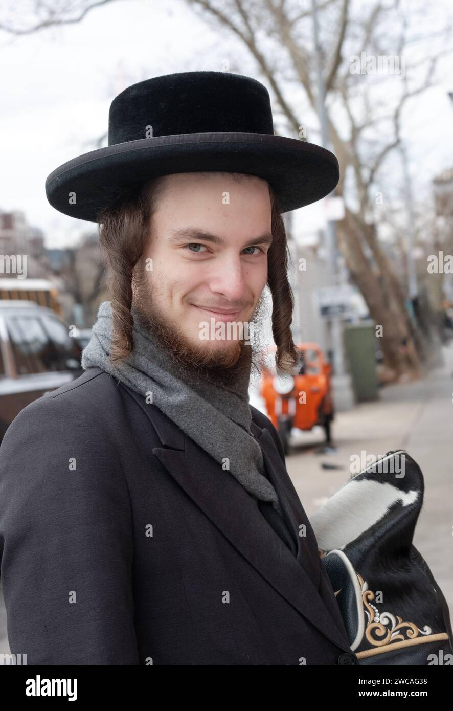 Posed portrait of a smiling Hasidic man with long curled peyus. On a winter  day in late 2023 in Brooklyn,, New York Stock Photo - Alamy