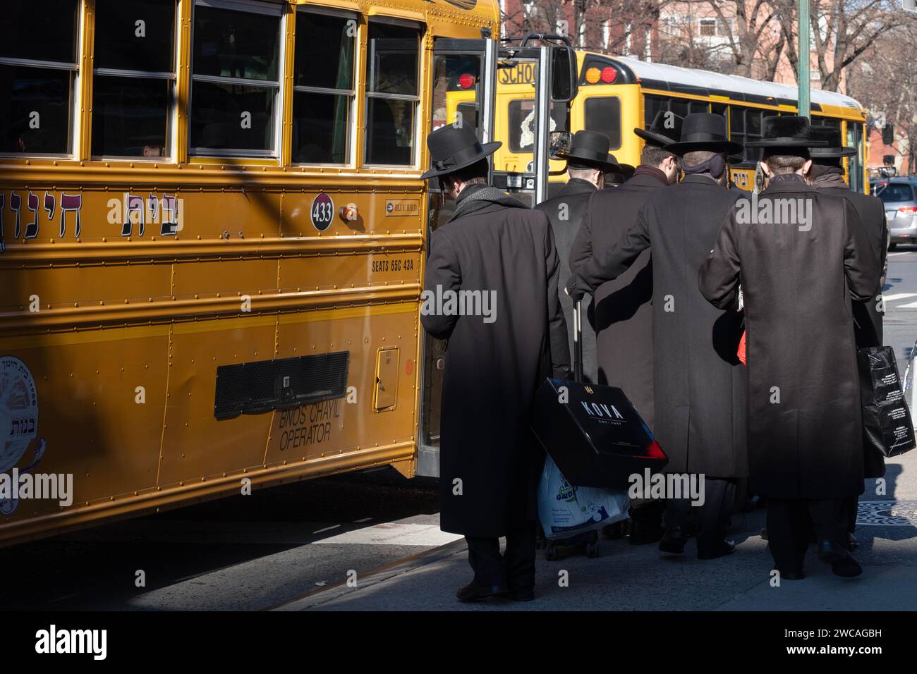 On a cold winter day, orthodox jewish young men board a bus to attend a Talmud study group on the other side of Brooklyn. Bedford Ave in Williamsburg. Stock Photo