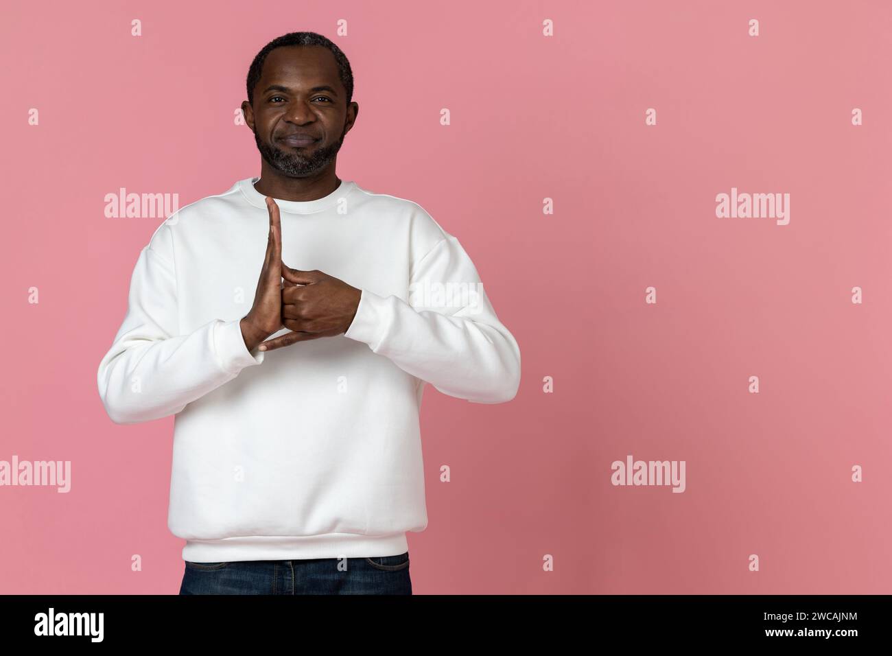 Black man wearing white sweatshirt using sign language Stock Photo