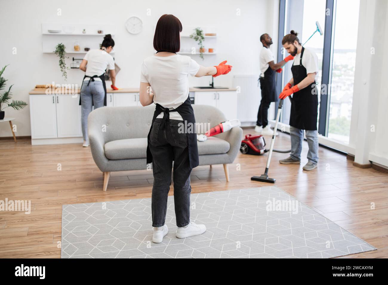 Female boss of company distributes tasks to employees and points to