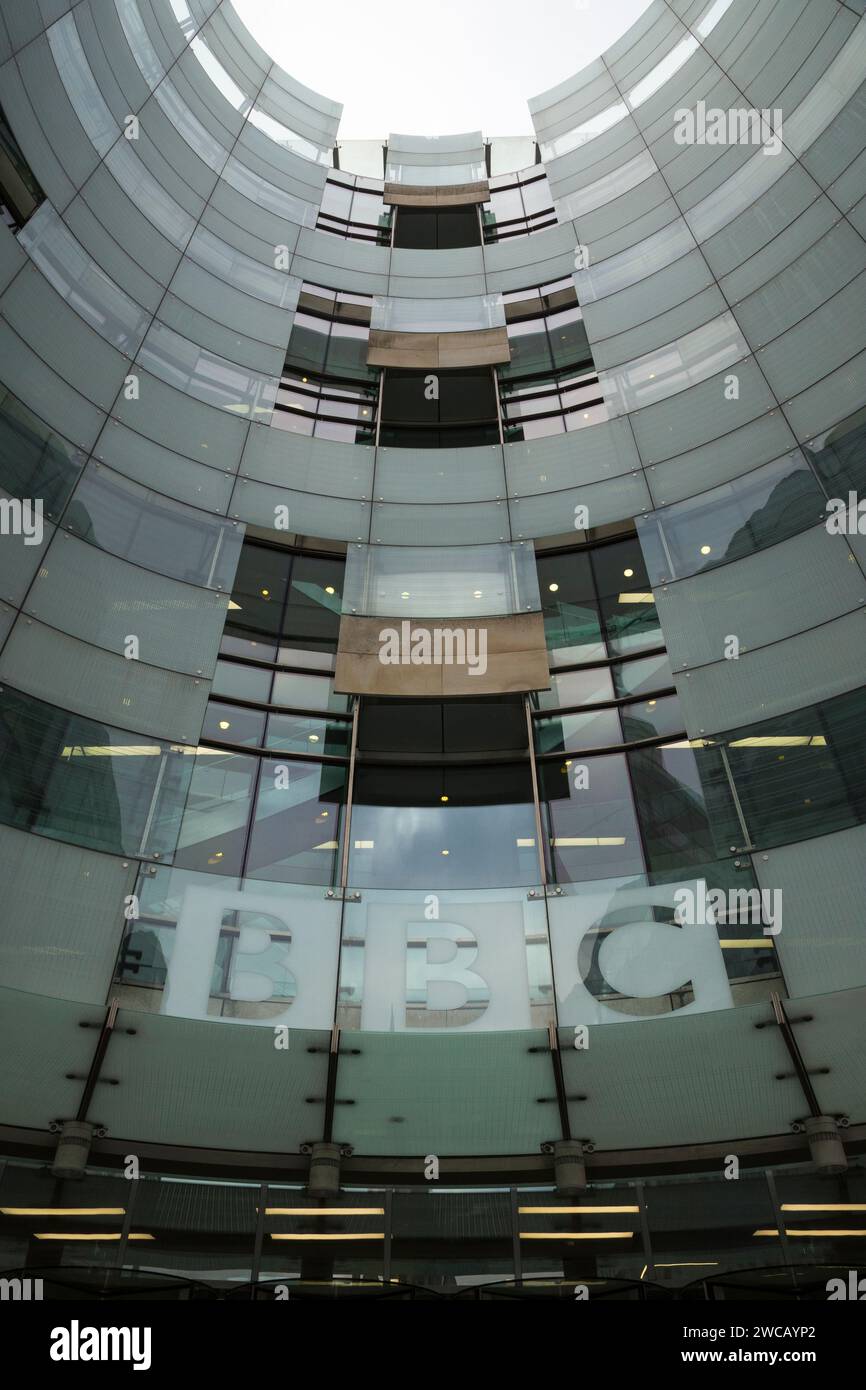 BBC logo letters above entrance door / doors of broadcast centre extension of Broadcasting House building front facade. Portland Place. London. UK. (137) Stock Photo